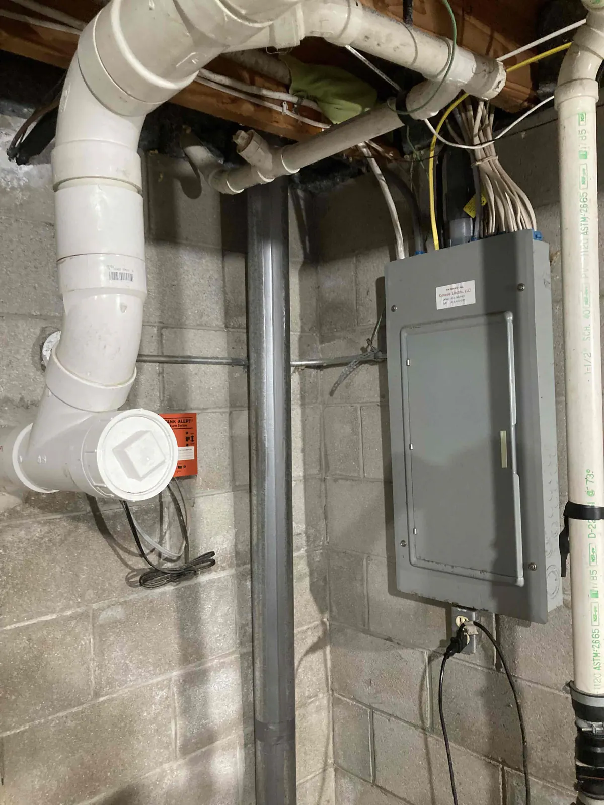 BEFORE: Outdated electrical conduit and panel at a home in Mukwonago — replacement by Jim, O'Leary Plumbing, Heating & Electrical.