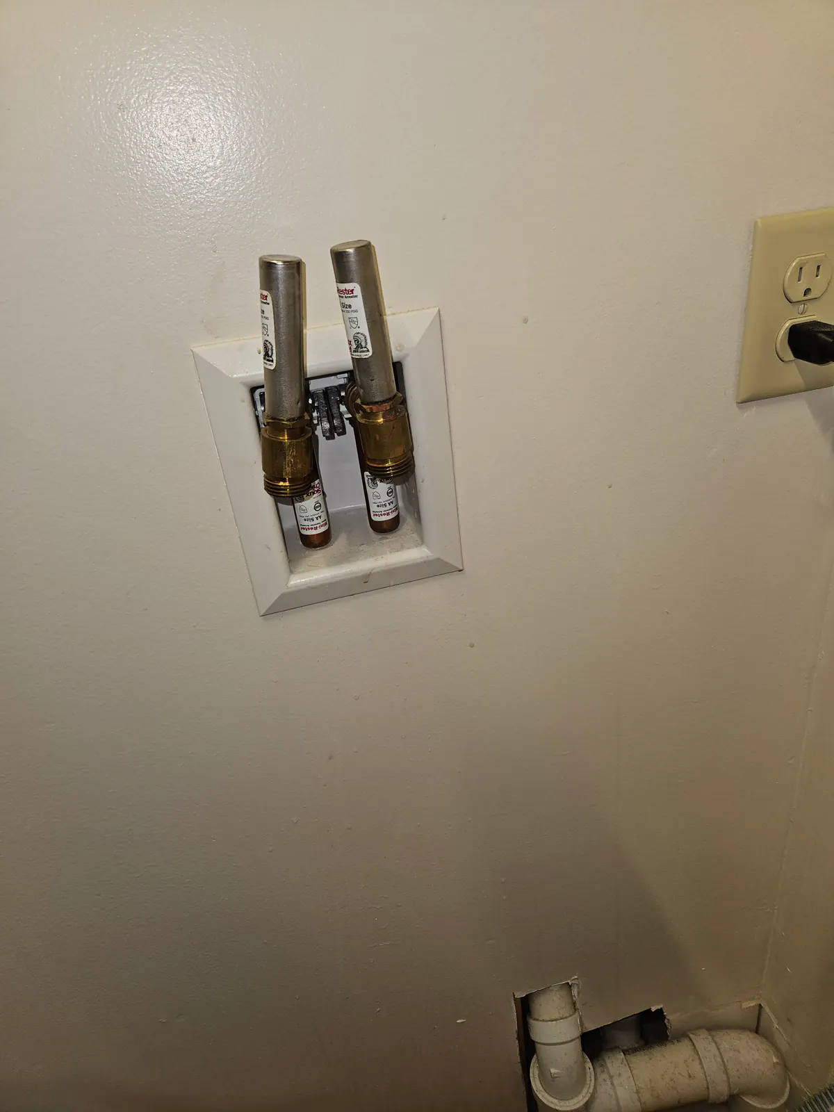 AFTER: Washer disconnected and lines secured at a home in Big Bend — by Nick, O'Leary Plumbing, Heating & Electrical.