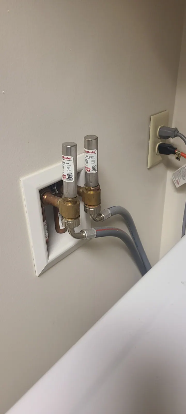 BEFORE: Washer connections at a home in Big Bend before service — by Nick, O'Leary Plumbing, Heating & Electrical.