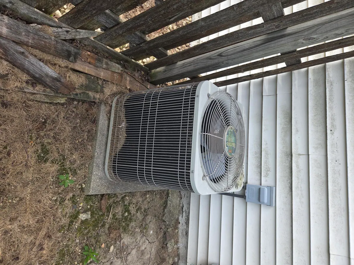 BEFORE: Aging outdoor A/C condenser at a home in Genoa City — by Cody & Kyle, O'Leary Plumbing, Heating & Electrical.