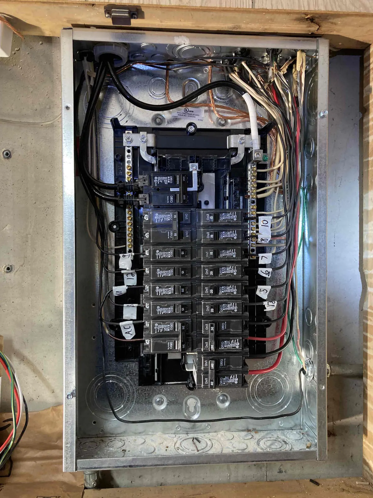 BEFORE: Old electrical panel at a home in Delavan — upgrade by Jim, O'Leary Plumbing, Heating & Electrical.