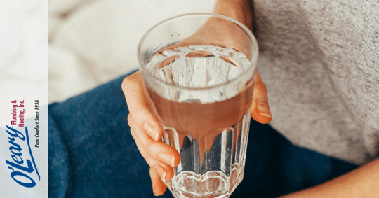 woman holding glass of water