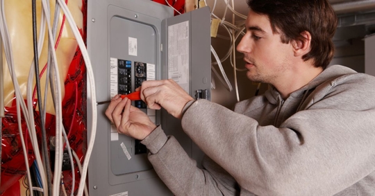man working on electrical panel