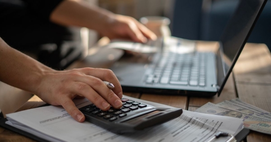 person calculating costs