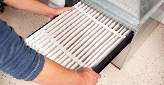 man changing HVAC filter