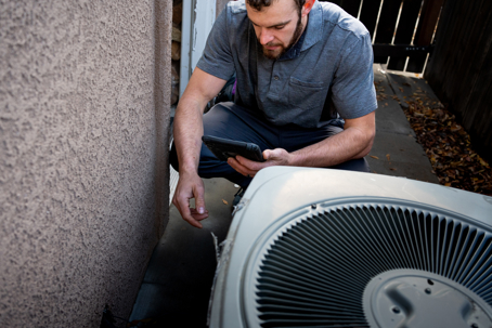 man repairing AC