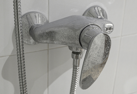 calcified faucet in the shower