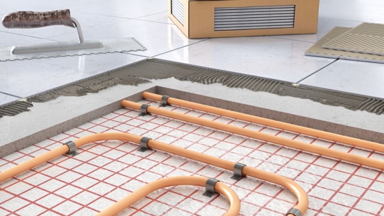 Radiant heating tubes being installed under flooring