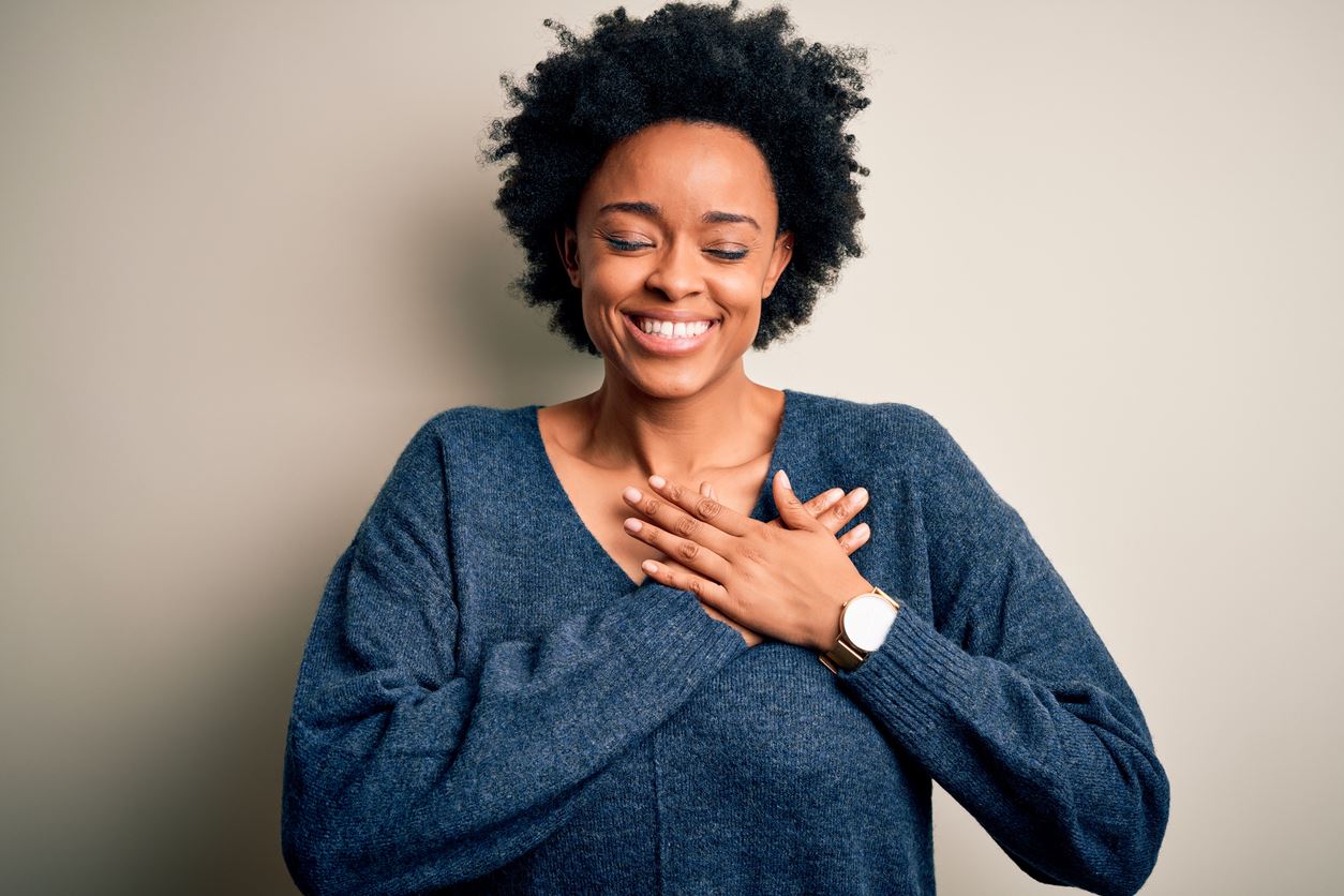 Woman with hand over her heart